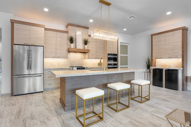2596 S Gritton St, Hurricane, UT 84737 - kitchen with visible vents, a breakfast bar, a sink, tasteful backsplash, and appliances with stainless steel finishes