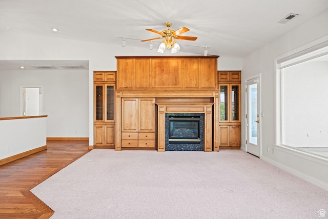 unfurnished living room with recessed lighting, a ceiling fan, a high end fireplace, visible vents, and baseboards