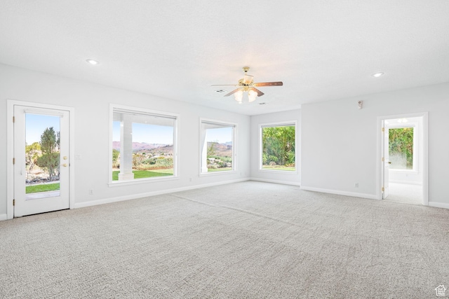 empty room with recessed lighting, light carpet, and baseboards