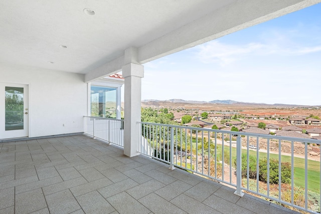 balcony with a residential view and a mountain view