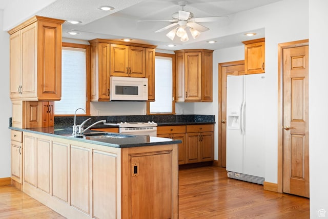 kitchen featuring light wood-style flooring, recessed lighting, a peninsula, white appliances, and a ceiling fan