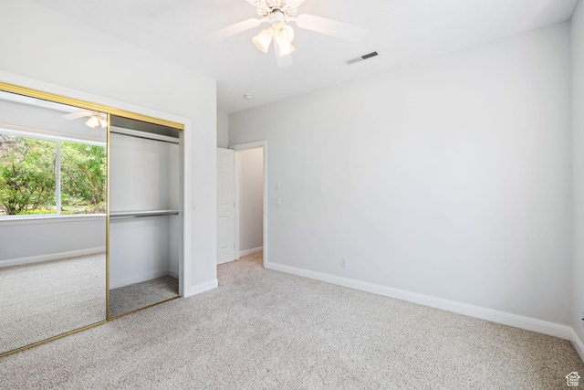 unfurnished bedroom with carpet floors, a closet, visible vents, ceiling fan, and baseboards