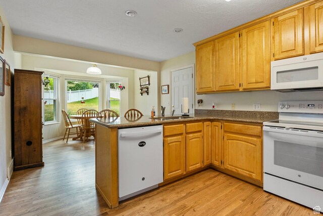 546 E River Meadow Dr S, Alpine, UT 84004 - kitchen with white appliances, light wood-style flooring, a sink, and a peninsula