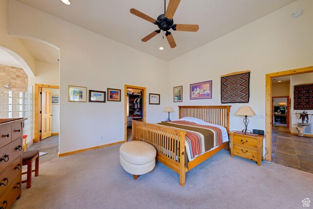 431 E Coronado Ln, Moab, UT 84532 - bedroom featuring arched walkways, a walk in closet, carpet, and a towering ceiling