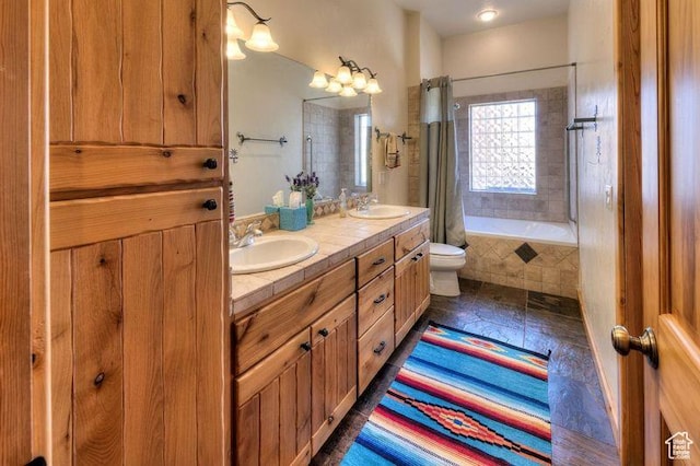 431 E Coronado Ln, Moab, UT 84532 - bathroom with a sink, tiled shower / bath, toilet, and double vanity
