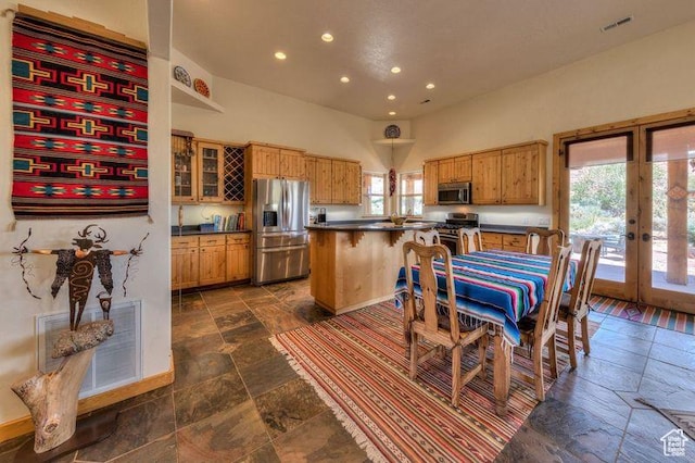 431 E Coronado Ln, Moab, UT 84532 - kitchen with visible vents, dark countertops, stone tile flooring, french doors, and appliances with stainless steel finishes