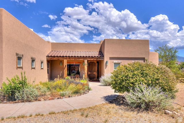 431 E Coronado Ln, Moab, UT 84532 - pueblo-style home with a tiled roof and stucco siding