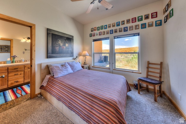 431 E Coronado Ln, Moab, UT 84532 - bedroom featuring connected bathroom, carpet floors, baseboards, and ceiling fan