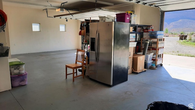 431 E Coronado Ln, Moab, UT 84532 - garage featuring a garage door opener and stainless steel fridge with ice dispenser