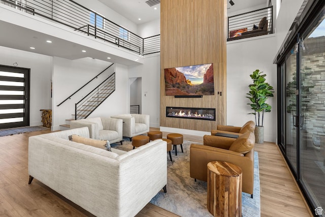 living room featuring light hardwood / wood-style floors and a high ceiling