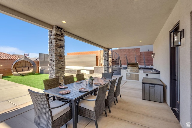 view of patio / terrace with a grill, exterior kitchen, and sink