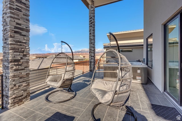 view of patio with a balcony and central air condition unit