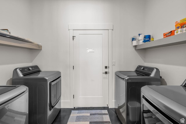 clothes washing area featuring washer and clothes dryer