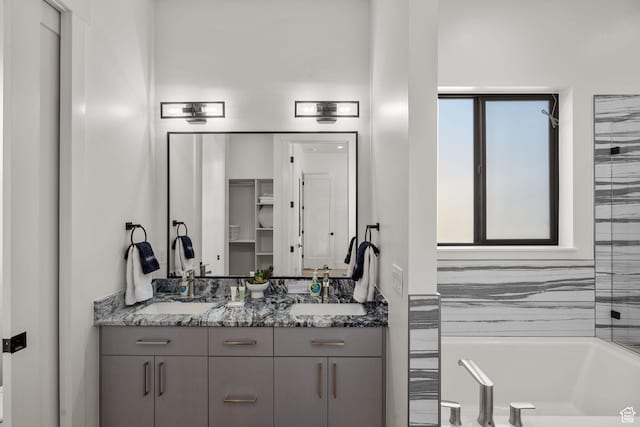 bathroom with vanity and a bathtub