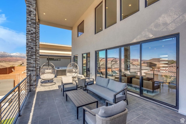 view of patio featuring a balcony and an outdoor hangout area