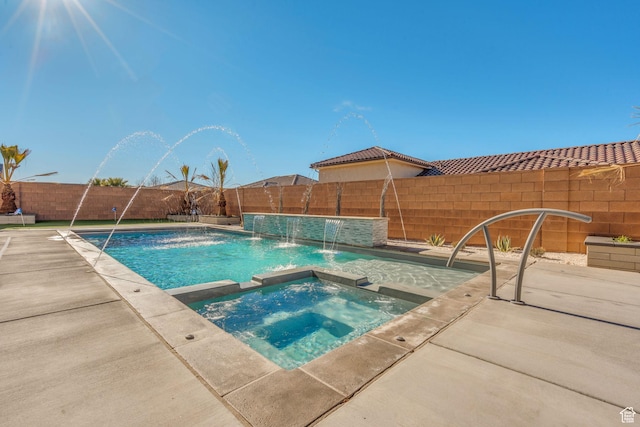 view of pool with pool water feature and an in ground hot tub