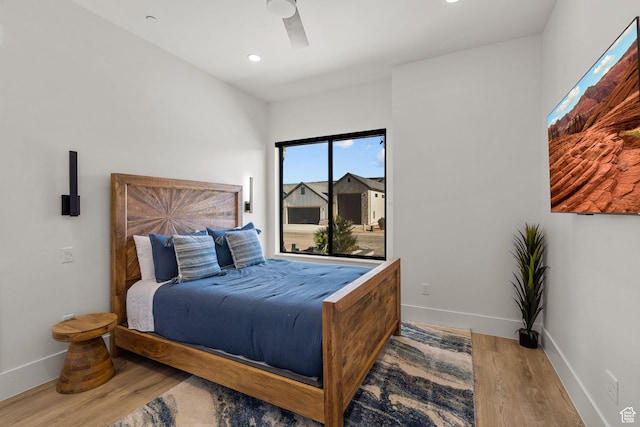 bedroom with ceiling fan and light hardwood / wood-style floors