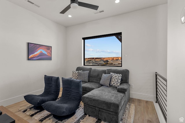 living area featuring light hardwood / wood-style flooring and ceiling fan