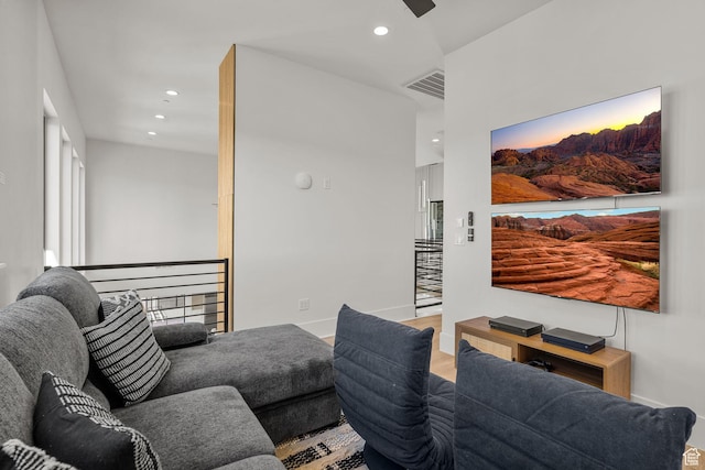 living room with hardwood / wood-style flooring and ceiling fan