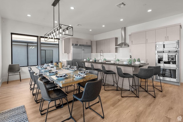 dining space with light hardwood / wood-style flooring