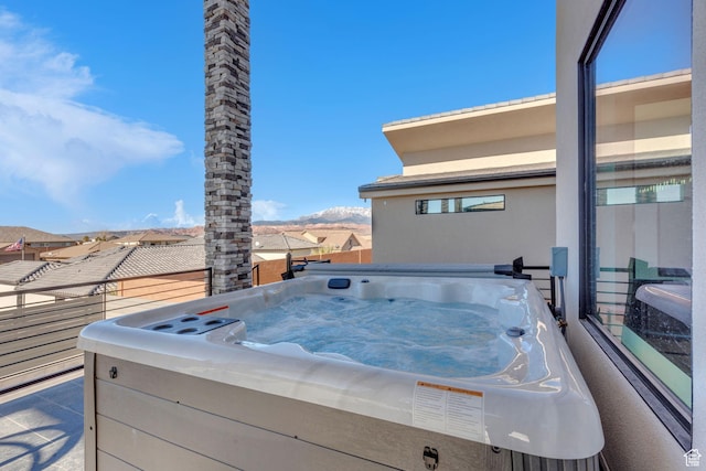 view of patio / terrace with a mountain view and a hot tub