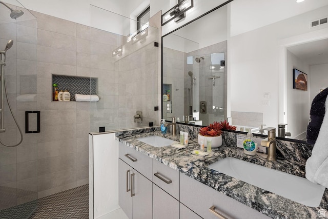 bathroom with walk in shower and vanity