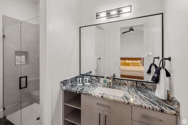 bathroom featuring vanity, ceiling fan, and walk in shower
