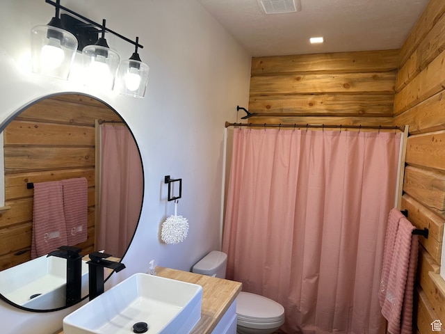 109 Gentle Ben Rd, Fish Haven, ID 83287 - full bath with curtained shower, wood walls, visible vents, toilet, and vanity