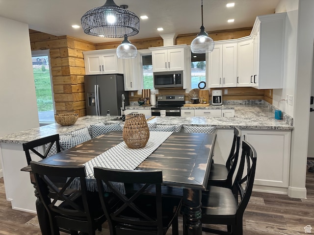 109 Gentle Ben Rd, Fish Haven, ID 83287 - kitchen featuring stainless steel appliances, a sink, dark wood-type flooring, light stone countertops, and white cabinetry