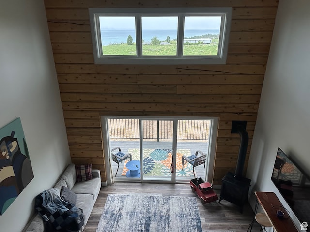 109 Gentle Ben Rd, Fish Haven, ID 83287 - living area featuring wood finished floors, a wood stove, wood walls, and a towering ceiling