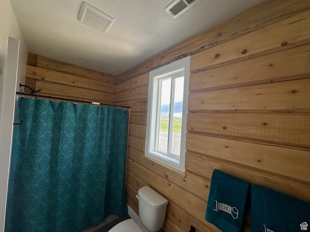 109 Gentle Ben Rd, Fish Haven, ID 83287 - bathroom with a shower with curtain, wooden walls, and visible vents
