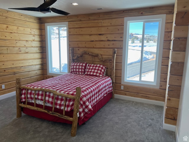 109 Gentle Ben Rd, Fish Haven, ID 83287 - bedroom featuring a ceiling fan, carpet floors, baseboards, wood walls, and visible vents