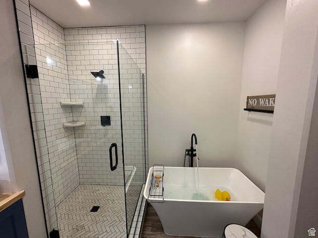 109 Gentle Ben Rd, Fish Haven, ID 83287 - bathroom with a shower stall, a soaking tub, wood finished floors, and recessed lighting