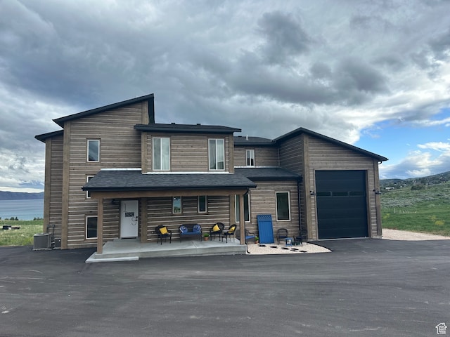 exterior space with central AC unit and a garage