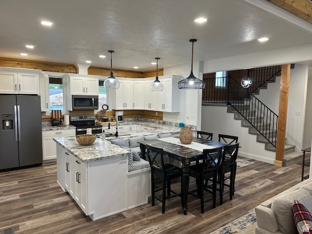 109 Gentle Ben Rd, Fish Haven, ID 83287 - kitchen featuring recessed lighting, dark wood-style floors, stainless steel appliances, light stone counters, and white cabinetry