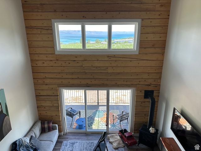 109 Gentle Ben Rd, Fish Haven, ID 83287 - living room featuring wood finished floors, wood walls, a wood stove, and a healthy amount of sunlight