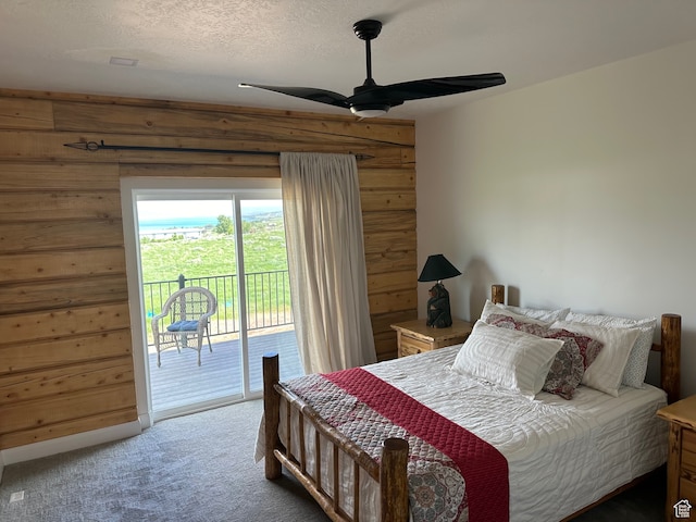 109 Gentle Ben Rd, Fish Haven, ID 83287 - carpeted bedroom featuring ceiling fan, a textured ceiling, wood walls, and access to outside