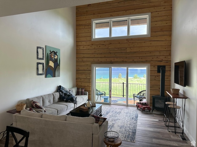 109 Gentle Ben Rd, Fish Haven, ID 83287 - living area featuring a high ceiling, wood walls, a wood stove, and wood finished floors