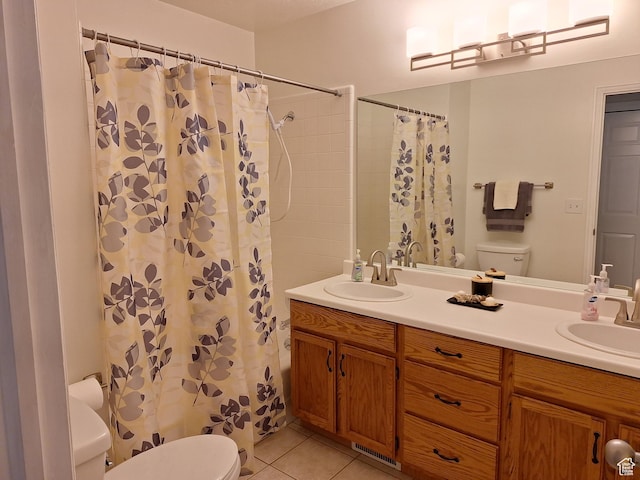 full bathroom featuring tile patterned floors, toilet, and a sink