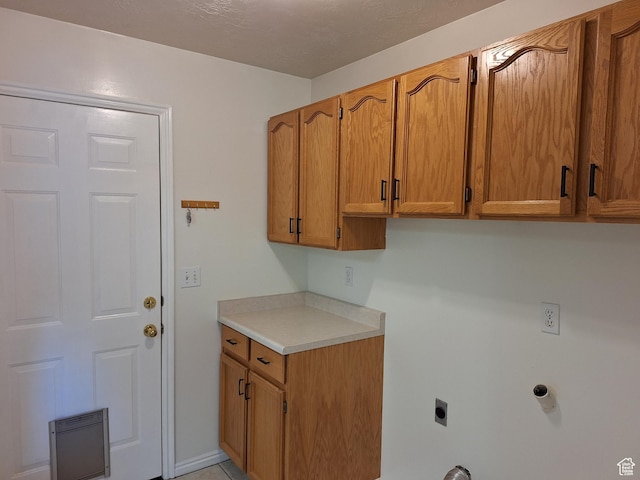 laundry area featuring cabinet space and hookup for an electric dryer