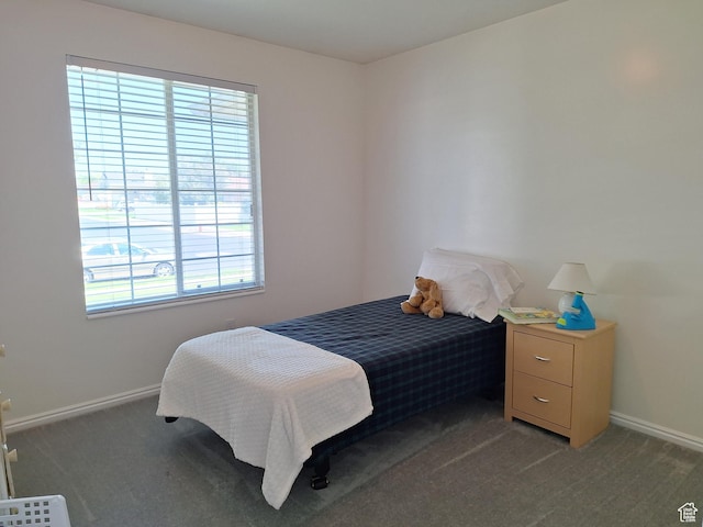 bedroom featuring baseboards and light carpet