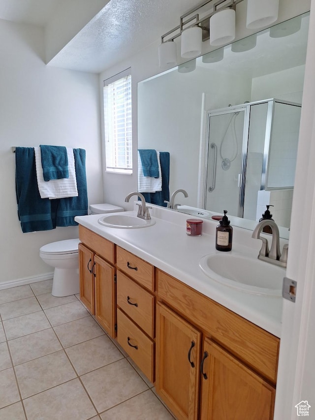 full bathroom with a sink, toilet, a shower stall, and tile patterned flooring