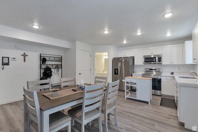 621 Plum Creek Ln, Ogden, UT 84404 - dining room with recessed lighting, light wood-style flooring, and baseboards