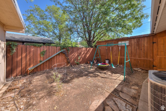 414 W Park Dr W Unit 14, Moab, UT 84532 - view of yard featuring cooling unit, a playground, and a fenced backyard