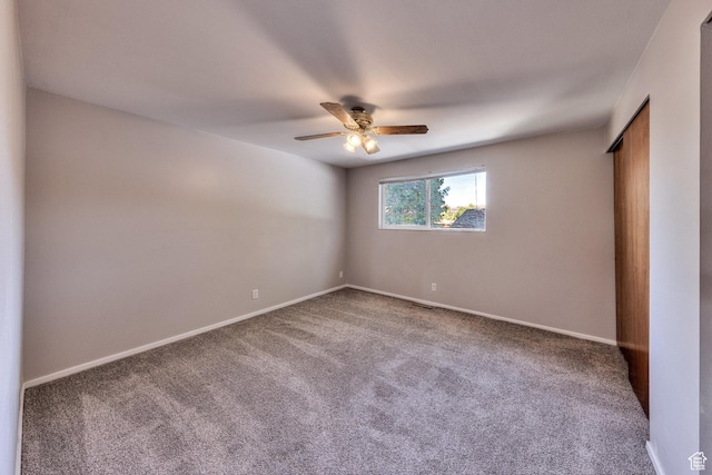 414 W Park Dr W Unit 14, Moab, UT 84532 - empty room featuring carpet flooring, a ceiling fan, and baseboards
