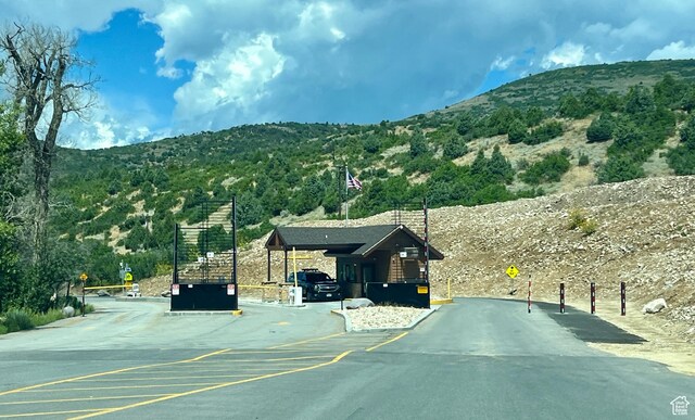 11523 E Cliffrose Dr E Unit 1692, Heber City, UT 84032 - view of road featuring traffic signs, a mountain view, and a gated entry