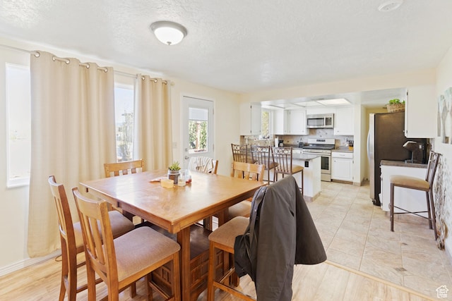 dining room featuring a textured ceiling