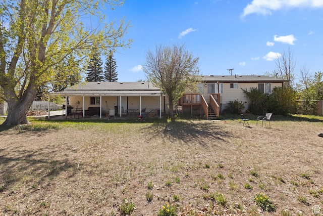 rear view of property with a patio area, a deck, and fence