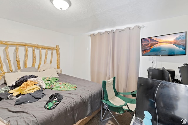 bedroom featuring carpet floors and a textured ceiling