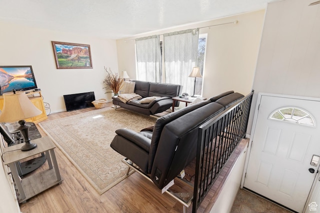 living room with baseboards and wood finished floors